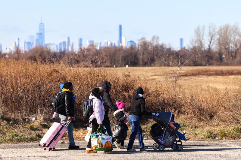 Migrants who arrived a few days ago from Eagle Pass, Texas, walk to Floyd Bennett Field on February 3, 2024