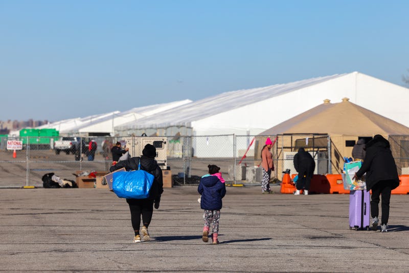 Migrants who arrived a few days ago from Eagle Pass, Texas, walk to the shelters at Floyd Bennett Field on February 3, 2024