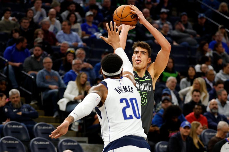 Luka Garza #55 of the Minnesota Timberwolves shoots the ball while Richaun Holmes #20 of the Dallas Mavericks defends in the fourth quarter at Target Center on January 31, 2024 in Minneapolis, Minnesota. The Timberwolves defeated the Mavericks 121-87.