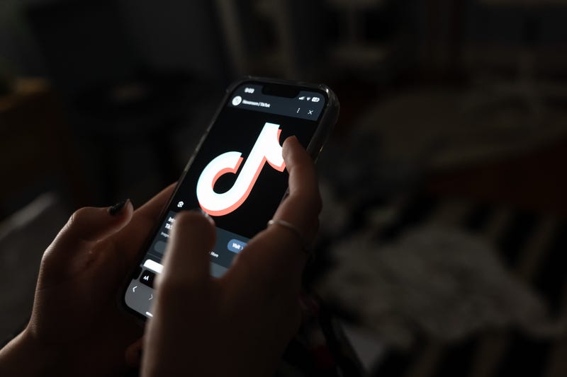 A teenager uses her mobile phone to access social media in New York City.