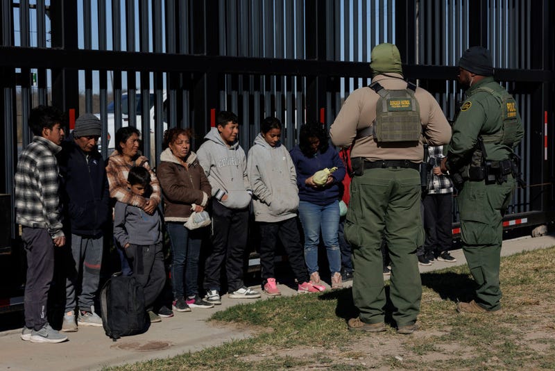 U.S. Border Patrol agents guard migrants that crossed into Shelby Park as they wait to be picked up for processing on February 4, 2024 in Eagle Pass, Texas. 