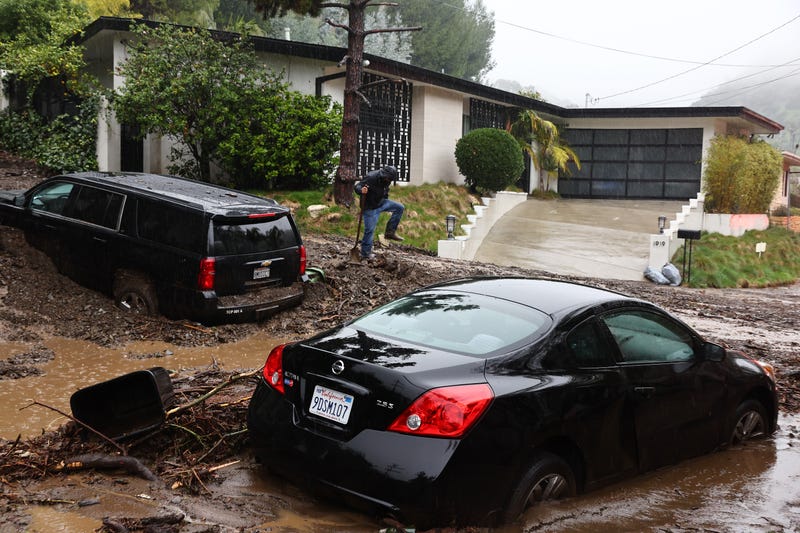 cars stuck in mud outside home