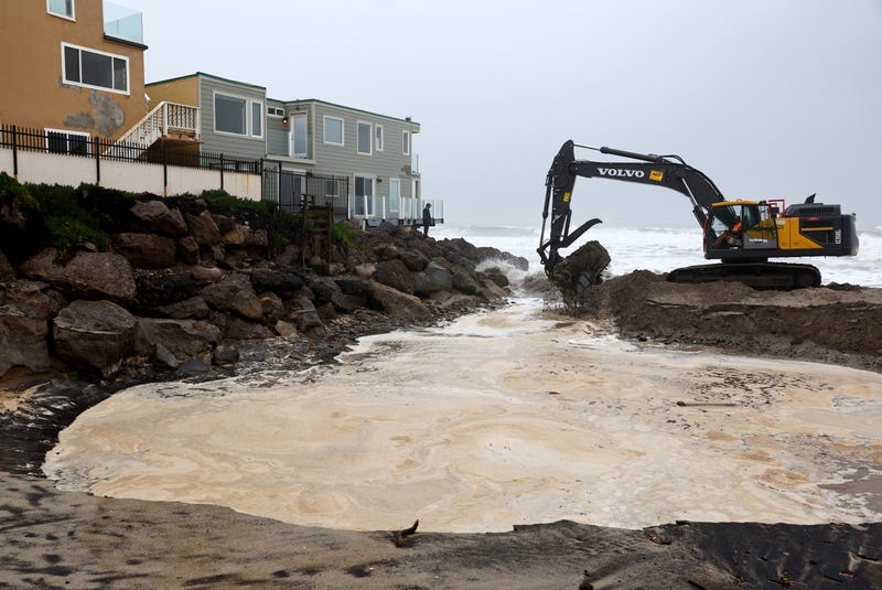 crane by houses near coastline