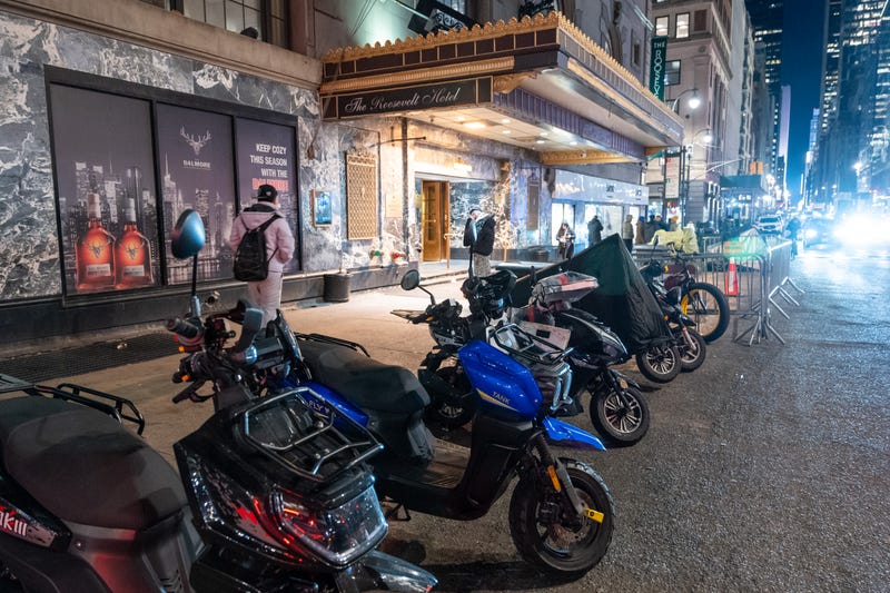 A few scooters remain in front of a hotel housing migrants in New York City. 