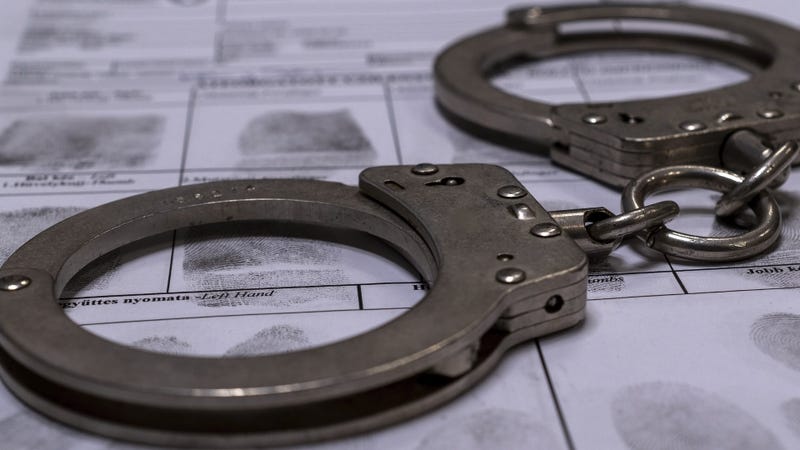 Handcuffs and fingerprint card - stock photo