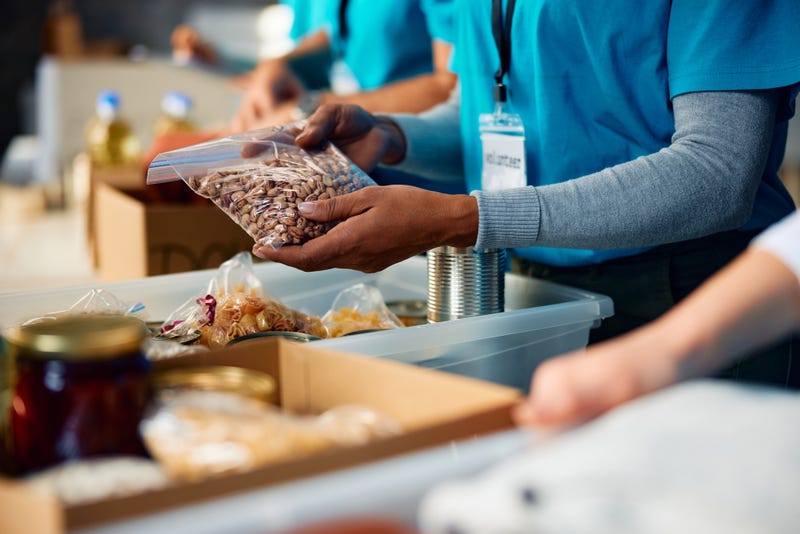 Stock photo of person loading food bank cart