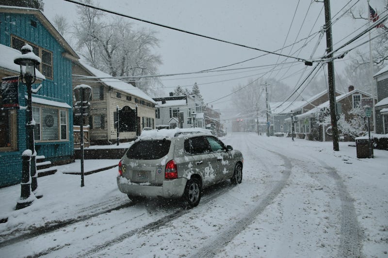 A car drives along Main Street as snow falls in Tappan, Rockland County, on February 10, 2024