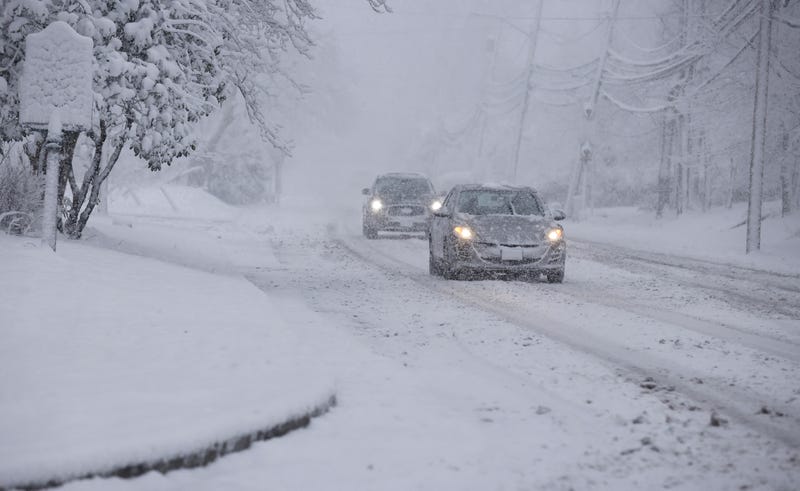 Commuters drive through snow in Norwood, New Jersey, on February 13, 2024