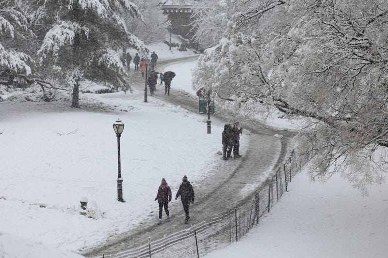 People walk through the snow in Central Park on February 13, 2024