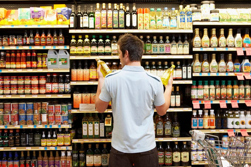 Man checking expiration dates on food items at the grocery store. 