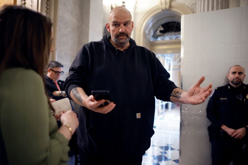 Sen. John Fetterman (D-PA) uses a speech-to-text app on his iPhone to better understand a reporter's questions in between votes at the U.S. Capitol on February 12, 2024 in Washington, DC.
