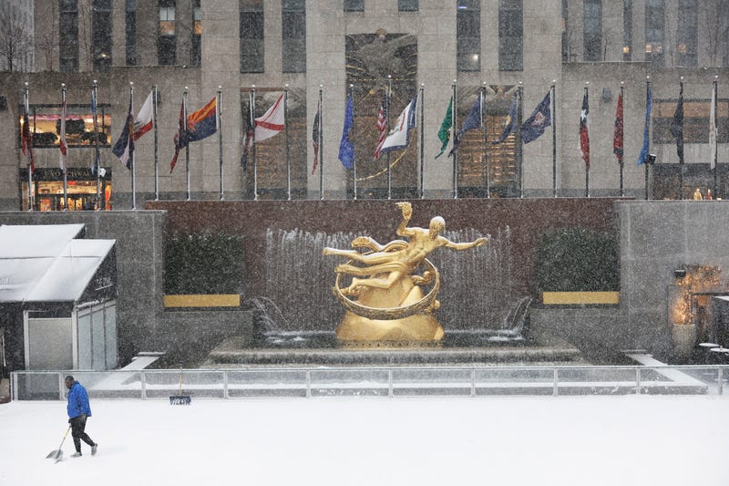 Snow is cleared off the ice rink at Rockefeller Center amid a winter storm on February 13, 2024