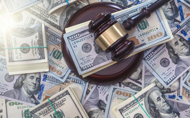 Judge hammer above dollar paper money background. Judgment and justice concept