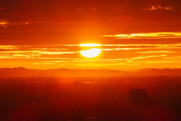 The hot sun over a city.