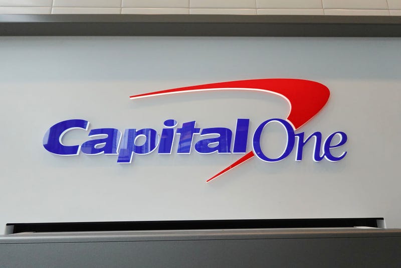 A sign above an ATM at a Capital One Café on February 19, 2024, in Miami, Florida. Capital One announced plans to buy Discover Financial Services in a deal that, if completed, would merge two of the largest credit card companies in the United States. (Photo by Joe Raedle/Getty Images)