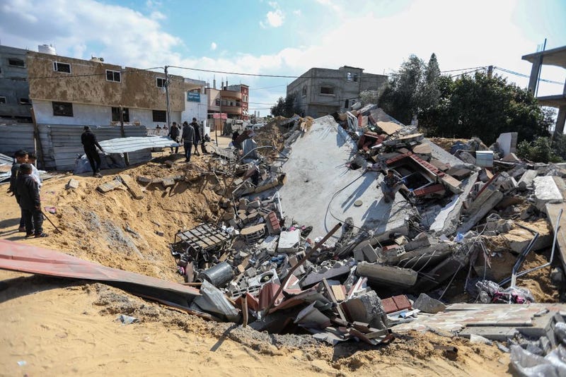 People inspect the damage to their homes following Israeli air strikes on February 20, 2024 in Rafah, Gaza. Strikes have intensified as Israel reiterated its intent to press on with a ground offensive in Gaza's southern city of Rafah where some 1.4 million internally displaced Palestinians are sheltering, whilst a growing number of countries express alarm over the operation. 