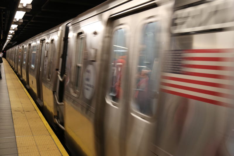 aTwo men were stabbed and slashed at Manhattan subway stations Monday night, police said