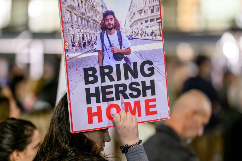 A woman holds a sign reading "Bring Hersh home" -- referring to American-Israeli hostage Hersh Goldberg-Polin -- as people gather outside the HaKirya base which serves as the IDF's headquarters to demand the return of the hostages held by Hamas on February 24, 2024 in Tel Aviv, Israel. 