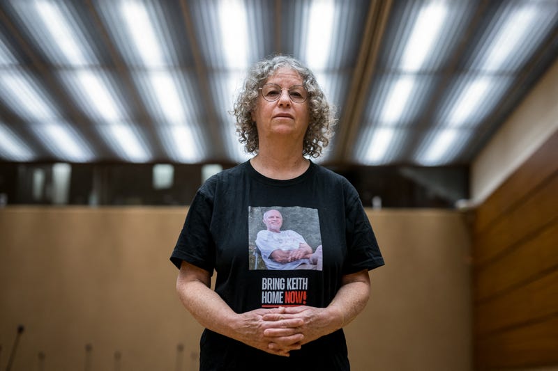Former Hamas hostage Aviva Siegel poses with a t-shirt showing a picture of her husband Keith Siegel during an interview with AFP during her visit to the 55th session of the UN Human Rights Council in Geneva on February 28, 2024