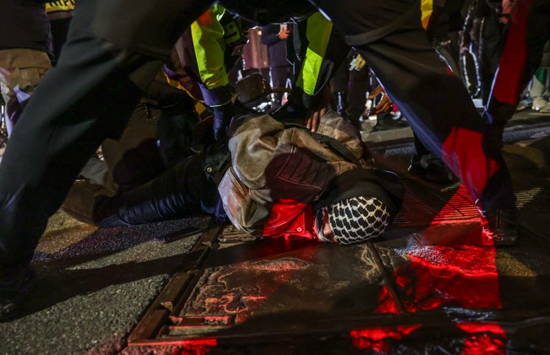 Police arrest a masked protester in Union Square on Feb. 29, 2024