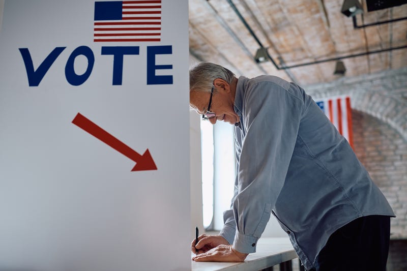 An older man votes.