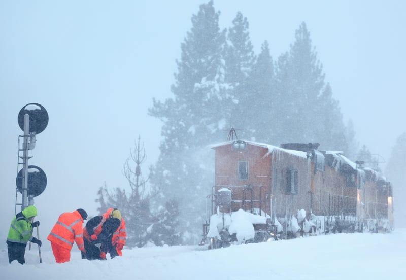 Union Pacific railroad workers clear snow from train tracks during a powerful multiple day winter storm in the Sierra Nevada mountains on March 03, 2024 in Truckee, California
