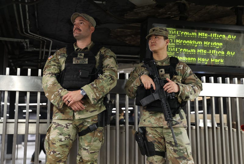 Security forces, including National Guard troops, take security measures at a subway station in New York on March 7, 2024.