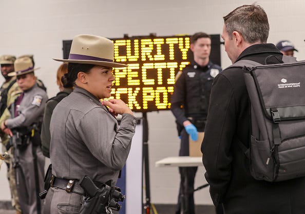 Police officers check passengers' bags as security forces, including National Guard troops and police, take security measures at a subway station in New York on March 7, 2024.