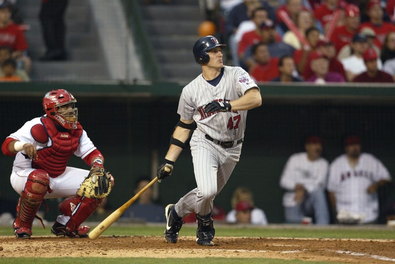 Third baseman Corey Koskie #47 of the Minnesota Twins watches the ball in flight after contact during Game four of the American League Championship Series against the Anaheim Angels at Edison International Field on October 12, 2002 in Anaheim, California.