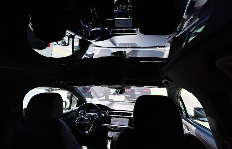 A Waymo autonomous self-driving Jaguar taxi drives along a street on March 14, 2024 in Los Angeles, the day the company launched robotaxis in a specific area of the city.