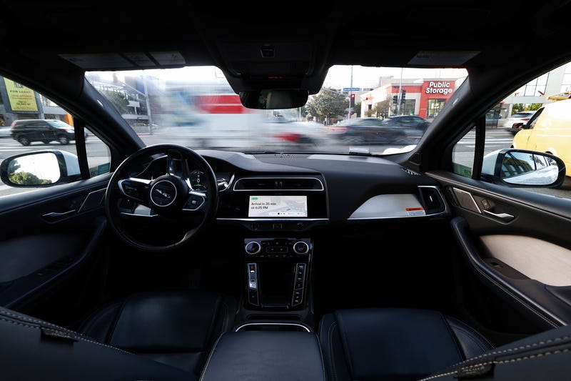 LOS ANGELES, CALIFORNIA - MARCH 14: A Waymo autonomous self-driving Jaguar taxi is stopped at a red light on March 14, 2024 in Los Angeles, California. Beginning today, Waymo One is offering robotaxi services in a 63-square mile area of greater Los Angeles including Santa Monica, Venice and downtown with over 50,000 people on the wait list. Waymo is owned by Alphabet, Google’s parent company. (Photo by Mario Tama/Getty Images)