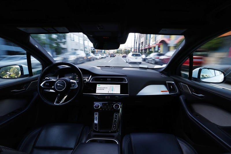 A Waymo autonomous self-driving Jaguar taxi drives along a street on March 14, 2024 in Los Angeles, California.