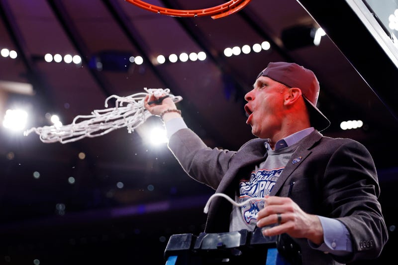 Head coach Dan Hurley of UConn cuts a piece of the net after winning the Big East championship over the Marquette Golden Eagles at Madison Square Garden, 3/16/24