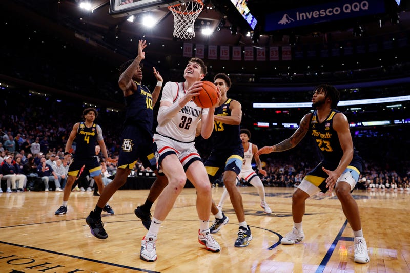 Donovan Clingan of UConn is triple-teamed in the second half during the Big East Basketball Tournament Final at Madison Square Garden in New York City, 3/16/24