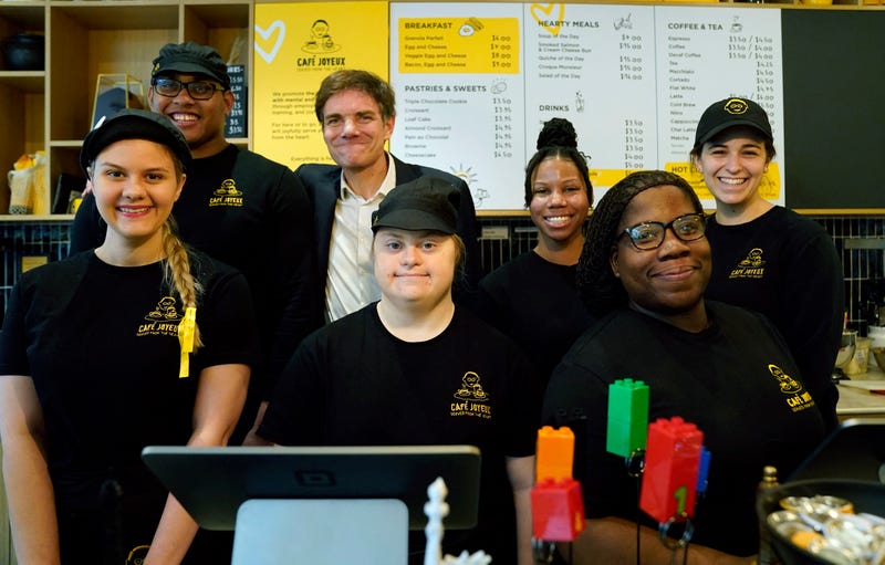 Co-founder of Café Joyeux Yann Bucaille-Lanrezac (3rd L) poses with employees at Café Joyeux's Manhattan location on March 15, 2024. "We arrive with a lot of humility," Bucaille-Lanrezac told AFP.