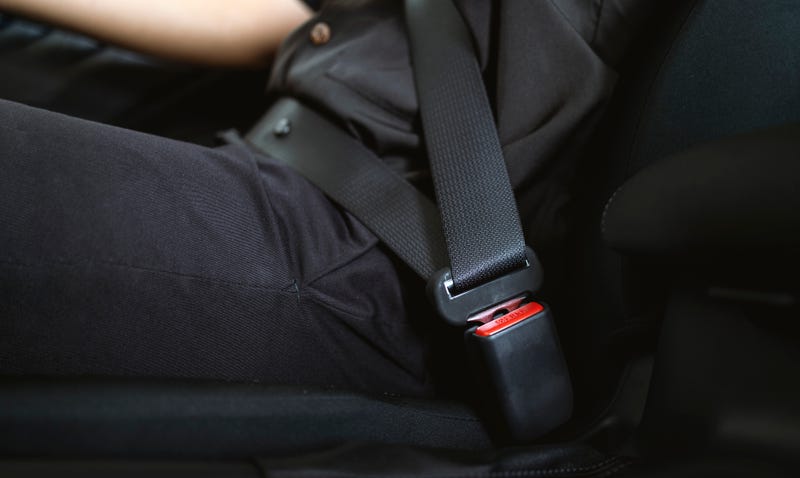 A man drives with his seat belt securely fastened 