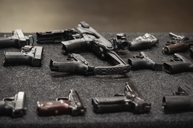 Several different firearms displayed on a table 