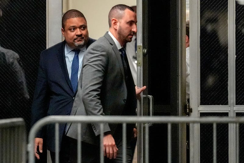 Manhattan district attorney Alvin Bragg, left, returns to court for a pre-trial hearing in a hush money case for former U.S. President Donald Trump in criminal court on March 25, 2024.