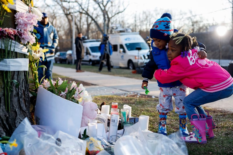 Julia Perkins, right, 5, holds her little brother, Josiah Perkins