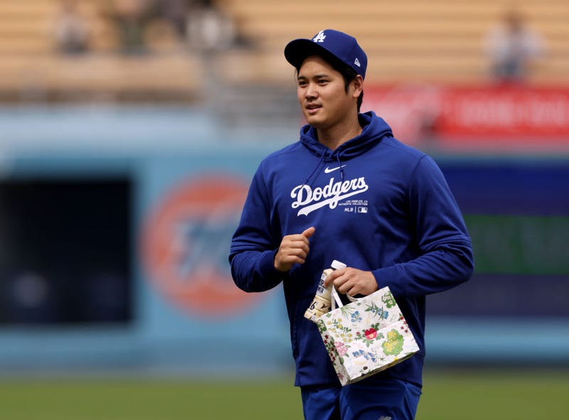Shohei Ohtani #17 of the Los Angeles Dodgers walks on the field before a pre season game against the Los Angeles Angels at Dodger Stadium on March 24, 2024 in Los Angeles, California.