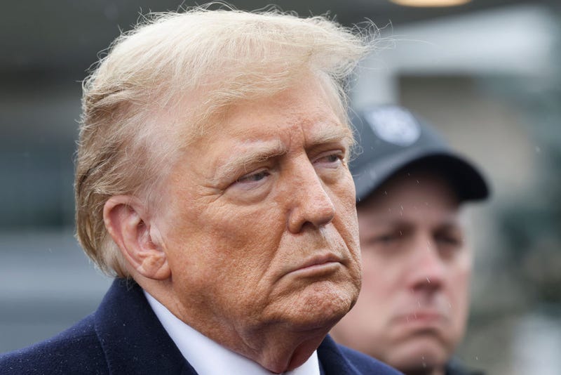 Former President Donald Trump stands silently after giving a brief statement after attending the wake for slain NYPD Officer Jonathan Diller at the Massapequa Funeral Home on March 28, 2024 in Massapequa, New York. 