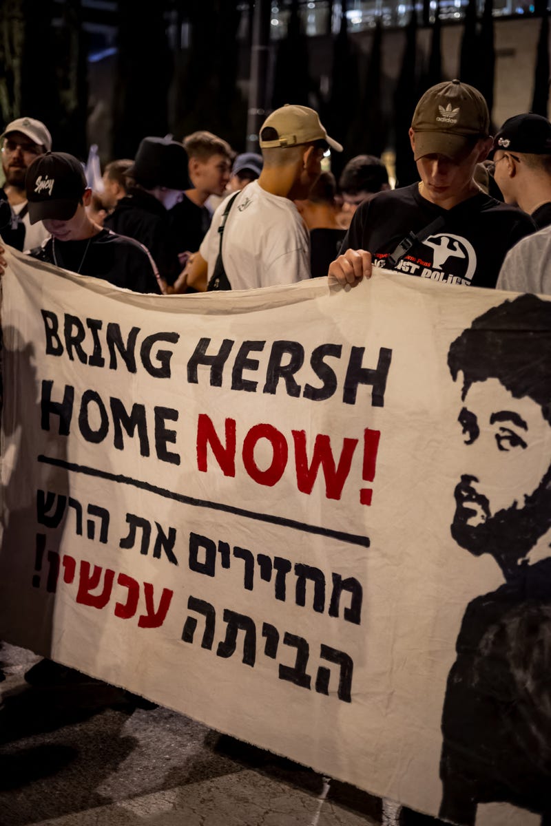 Friends of the kidnapped Hersh Goldberg-Polin hold a sign calling for his return at a demonstration for the kidnapping deal near the Knesset, on March 31, 2024, in Jerusalem Israel. 