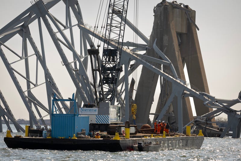 Debris is cleared from the collapsed Francis Scott Key Bridge.