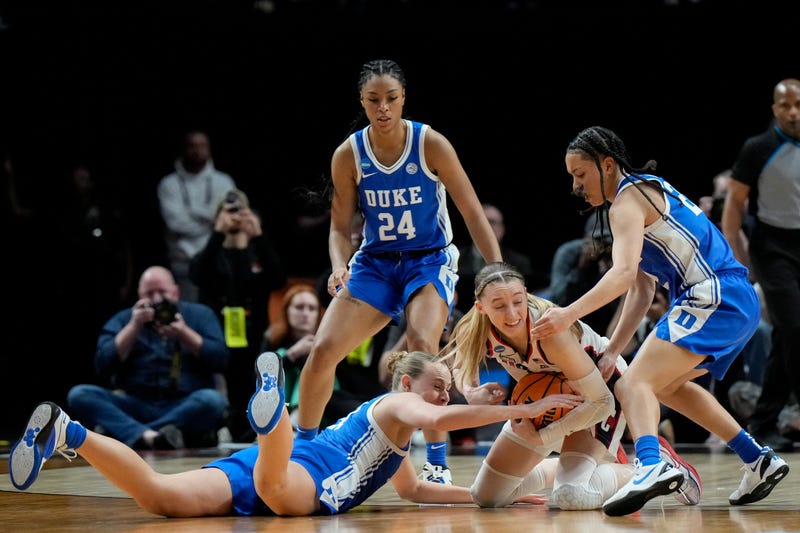 Camilla Emsbo #21 and Taina Mair #22 of the Duke Blue Devils attempt to steal the ball from Paige Bueckers #5 of the Connecticut Huskies during the second half in the Sweet 16 round of the NCAA Women's Basketball Tournament at Moda Center on March 30, 2024 in Portland, Oregon. 
