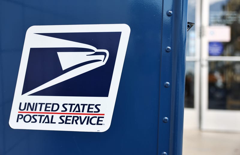 A United States Postal Service logo is displayed on a U.S. Post Office mailbox.