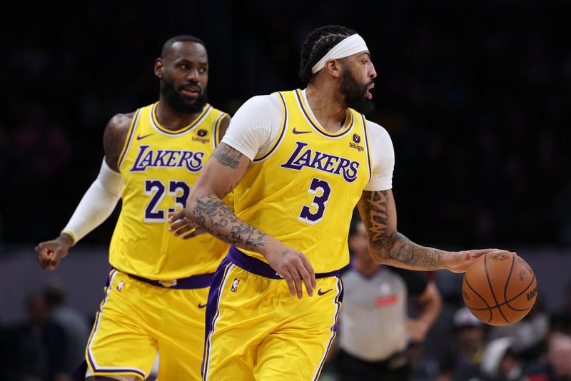 Anthony Davis #3 of the Los Angeles Lakers dribbles in front of LeBron James #23 of the Los Angeles Lakers during the first half at Capital One Arena on April 03, 2024 in Washington, DC. 
