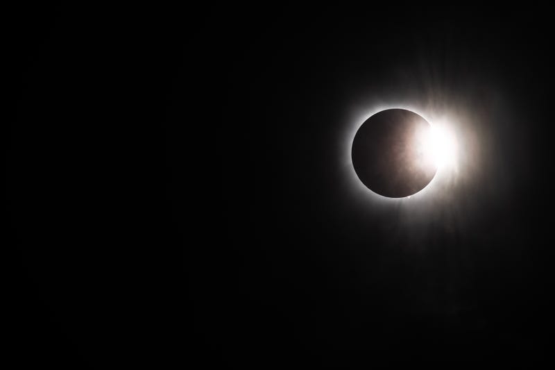 The moon begins its descent below the sun's horizon during a total solar eclipse on April 08, 2024 in Brady, Texas. Millions of people have flocked to areas across North America that are in the "path of totality" in order to experience the eclipse today. During the event, the moon will pass in between the Sun and the Earth, appearing to block the Sun. 