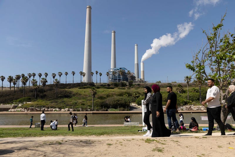 People hang out at the beach near the Orot Rabin Power Station amid fears of Iran attack after it blamed Israel for a strike on its consulate in Syria on April 12, 2024 in Hadera, Israel. April 7th marked six months since Hamas led an attack on Israel, killing 1,200 people and taking around 250 people hostage. In response, Israel launched a retaliatory war in Gaza that has killed more than 33,000 people, according to the Gazan health ministry. As the latest round of ceasefire negotiations have stalled, the humanitarian crisis worsens in Gaza, while more than 100 Israeli hostages remain in captivity. (Photo by Amir Levy/Getty Images)