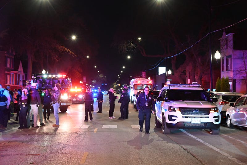 Police officers take security measures after 11 people, including seven adults and four children, were shot in Chicago's Back of the Yards neighborhood on April 13, 2024. An 8-year-old girl died after the shooting.