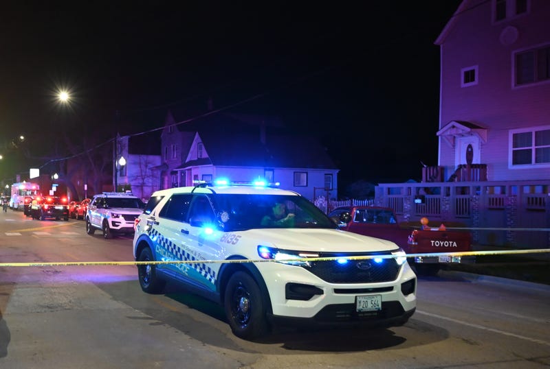 Police officers take security measures after 11 people, including seven adults and four children, were shot in Chicago's Back of the Yards neighborhood on April 13, 2024. One child was killed in the attack.